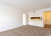 Thumbnail 9 of 19 - A room with white walls and a carpeted floor.