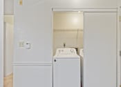 Thumbnail 19 of 19 - A white laundry room with a washer and dryer.