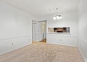 Thumbnail 14 of 19 - A room with white walls and a carpeted floor.