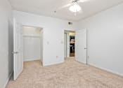 Thumbnail 17 of 19 - A white room with a carpeted floor and a ceiling fan.