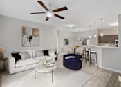 Thumbnail 4 of 22 - A living room with a white couch and a ceiling fan.