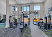 Thumbnail 19 of 50 - a fitness center with cardio equipment and resistance training at Tapestry Overbrook in McDonough, Georgia