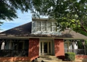 Thumbnail 27 of 28 - the front of a brick house with a porch and a black railing