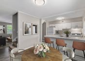 Thumbnail 2 of 22 - open concept kitchen with bar  Living Room with wood flooring at Midtown Oaks Townhomes in Mobile, AL