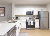 Thumbnail 3 of 25 - a kitchen with stainless steel appliances and white cabinets