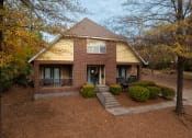 Thumbnail 24 of 28 - the front of a brick house with a yard and trees