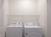 Thumbnail 55 of 55 - a washer and dryer in a room with a white wall at Artisan Flats in Birmingham, AL