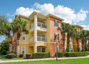 Thumbnail 32 of 33 - a building with palm trees in front of it