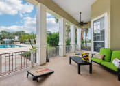 Thumbnail 21 of 33 - a balcony with a pool and a couch and a coffee table