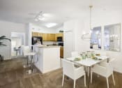 Thumbnail 5 of 33 - a dining room and kitchen with a white table and chairs
