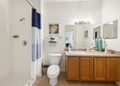 Thumbnail 9 of 33 - a bathroom with a toilet and a sink and a shower