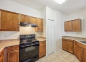 Thumbnail 3 of 33 - a kitchen with wooden cabinets and a stove and a sink