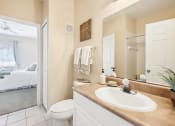 Thumbnail 7 of 33 - a bathroom with a sink and a toilet and a mirror