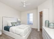 Thumbnail 8 of 33 - a bedroom with a bed and a ceiling fan