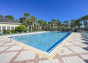 Thumbnail 18 of 33 - a large swimming pool with chairs around it