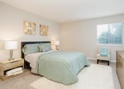 Thumbnail 10 of 31 - Primary bedroom with large windows and en-suite bathroom at Malibu at Martin Apartments in Huntsville, Alabama