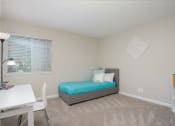 Thumbnail 13 of 31 - Guest bedroom with large window at Malibu at Martin Apartments in Huntsville, Alabama