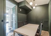 Thumbnail 33 of 50 - a dining room with a white table and chairs and a green wall