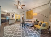 Thumbnail 2 of 21 - a living room with a couch and a ceiling fan