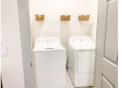 Thumbnail 13 of 34 - a small laundry room with a washer and dryer