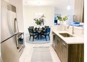 Thumbnail 6 of 34 - a kitchen and dining area in a 555 waverly unit
