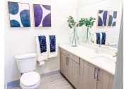 Thumbnail 11 of 34 - a bathroom with a toilet sink and mirror