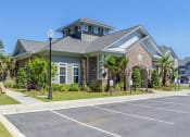Thumbnail 19 of 21 - a house with a parking lot in front of it
