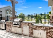 Thumbnail 18 of 21 - an outdoor kitchen with a grill and a sink