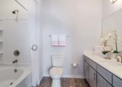 Thumbnail 8 of 21 - a bathroom with a toilet next to a bathtub