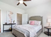 Thumbnail 7 of 21 - a bedroom with a bed and a ceiling fan