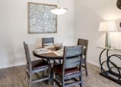 Thumbnail 6 of 21 - a dining room with a table and chairs
