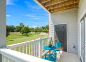 Thumbnail 9 of 21 - a patio with two chairs and a table on a balcony