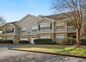 Thumbnail 31 of 34 - the front of a house with a driveway and lawn at 10X Audubon Park apartments in Daphne, AL 