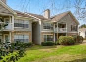 Thumbnail 30 of 34 - A row of houses with a green lawn in front at 10X Audubon Park apartments in Daphne, AL 