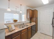 Thumbnail 3 of 34 - a kitchen with a sink and a refrigerator at 10X Audubon Park apartments in Daphne, AL 