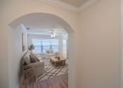 Thumbnail 11 of 34 - a living room with a couch and a table at 10X Audubon Park apartments in Daphne, AL 