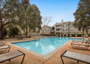 Thumbnail 12 of 34 - our apartments offer a swimming pool with our apartment buildings in the background at 10X Audubon Park apartments in Daphne, AL 