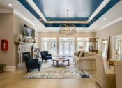 Thumbnail 16 of 34 - A living room with a fireplace and a large window at 10X Audubon Park apartments in Daphne, AL 
