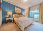 Thumbnail 9 of 21 - a bedroom with a bed and a window