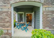 Thumbnail 10 of 21 - a patio with a table and chairs on a porch