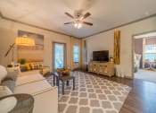 Thumbnail 3 of 21 - a living room filled with furniture and a ceiling fan