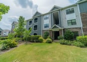 Thumbnail 21 of 21 - the front yard of an apartment building with grass and bushes
