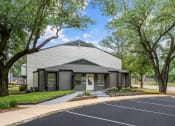 Thumbnail 14 of 24 - a white and gray building with trees in the background