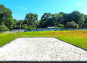 Thumbnail 23 of 25 - a volleyball court in the middle of a grass field