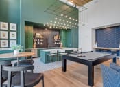 Thumbnail 32 of 50 - a game room with a pool table and tables