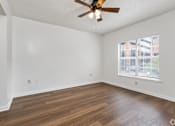 Thumbnail 7 of 9 - Empty room with a ceiling fan and a window.