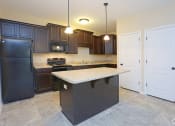 Thumbnail 3 of 18 - a kitchen with black appliances and a white counter top