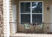 Thumbnail 10 of 18 - a patio with two chairs and a table on a porch