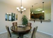 Thumbnail 5 of 18 - a dining room with a table and chairs