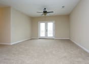 Thumbnail 4 of 18 - an empty living room with a ceiling fan